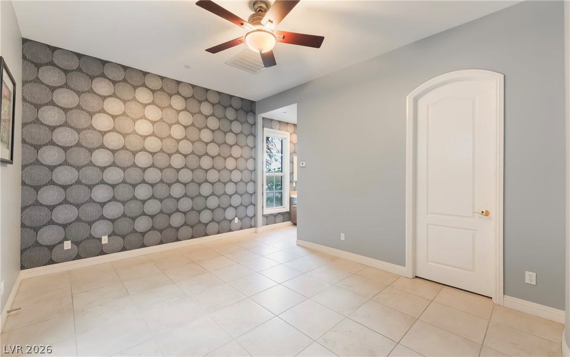 1343 Quiet River Avenue, Henderson, NV 89012 An arched doorway and smooth tile floors define this elegant, versatile living space.