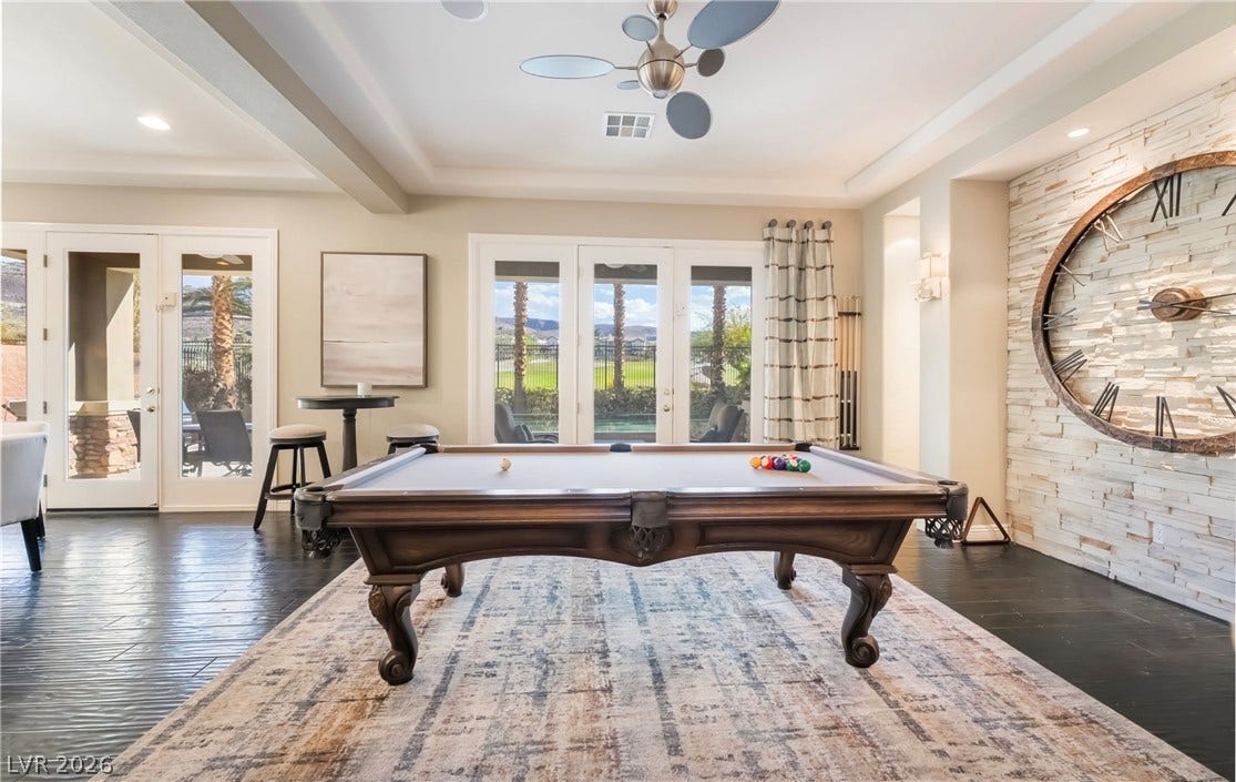 1343 Quiet River Avenue, Henderson, NV 89012 Double French doors open to the patio from this spacious game room with textured walls.