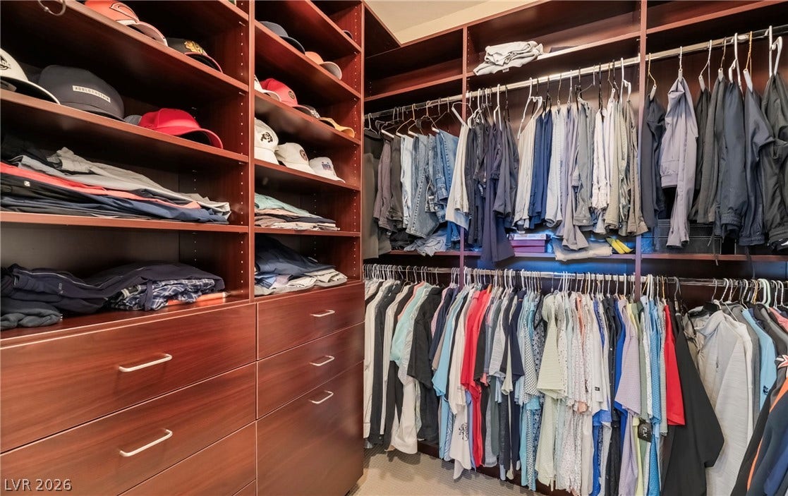 1343 Quiet River Avenue, Henderson, NV 89012 Rich wood built-ins provide ample organization options in this custom walk-in closet.