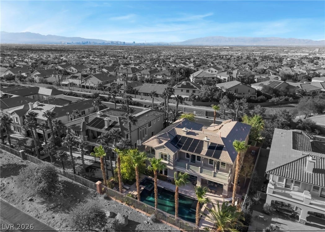 1343 Quiet River Avenue, Henderson, NV 89012 An elevated perspective showcases the private backyard pool, solar panels, and distant mountain views.