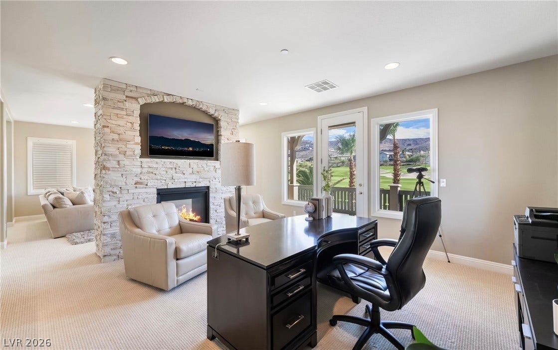 1343 Quiet River Avenue, Henderson, NV 89012 An integrated fireplace accents this refined workspace overlooking the golf course.