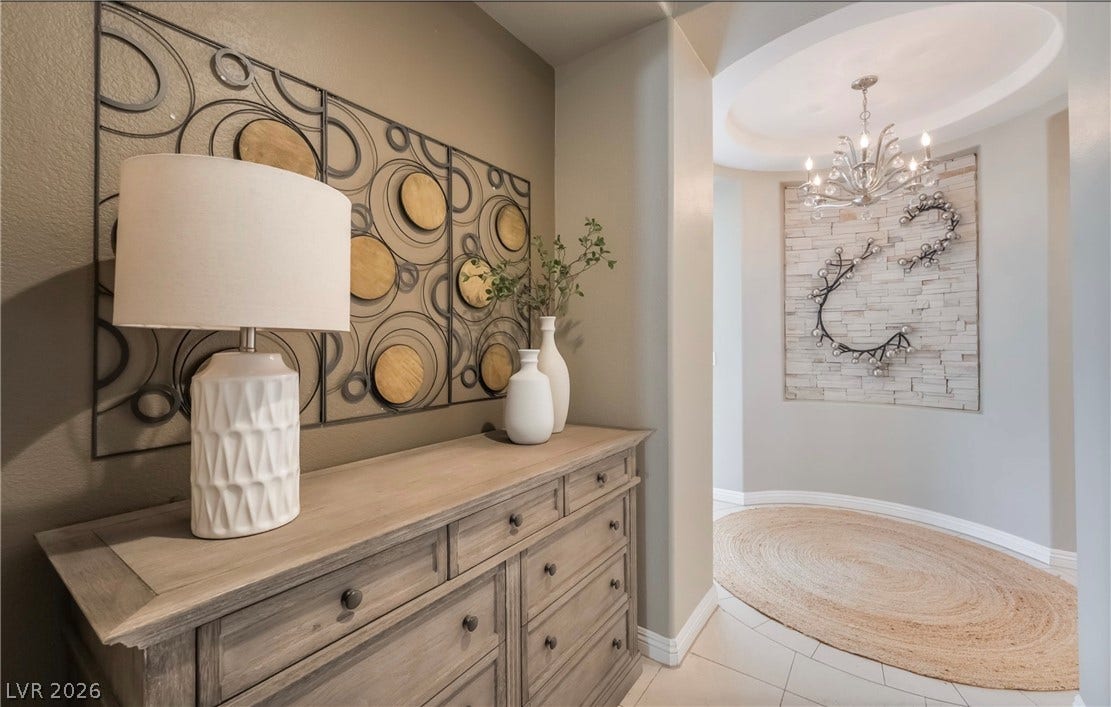 1343 Quiet River Avenue, Henderson, NV 89012 An elegant circular entry features a rotunda ceiling, tiled flooring, and a classic chandelier.