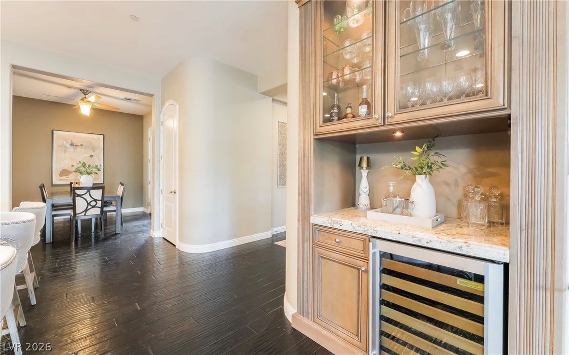 1343 Quiet River Avenue, Henderson, NV 89012 Gleaming hardwood floors guide the eye toward a custom bar and an adjacent dining area.