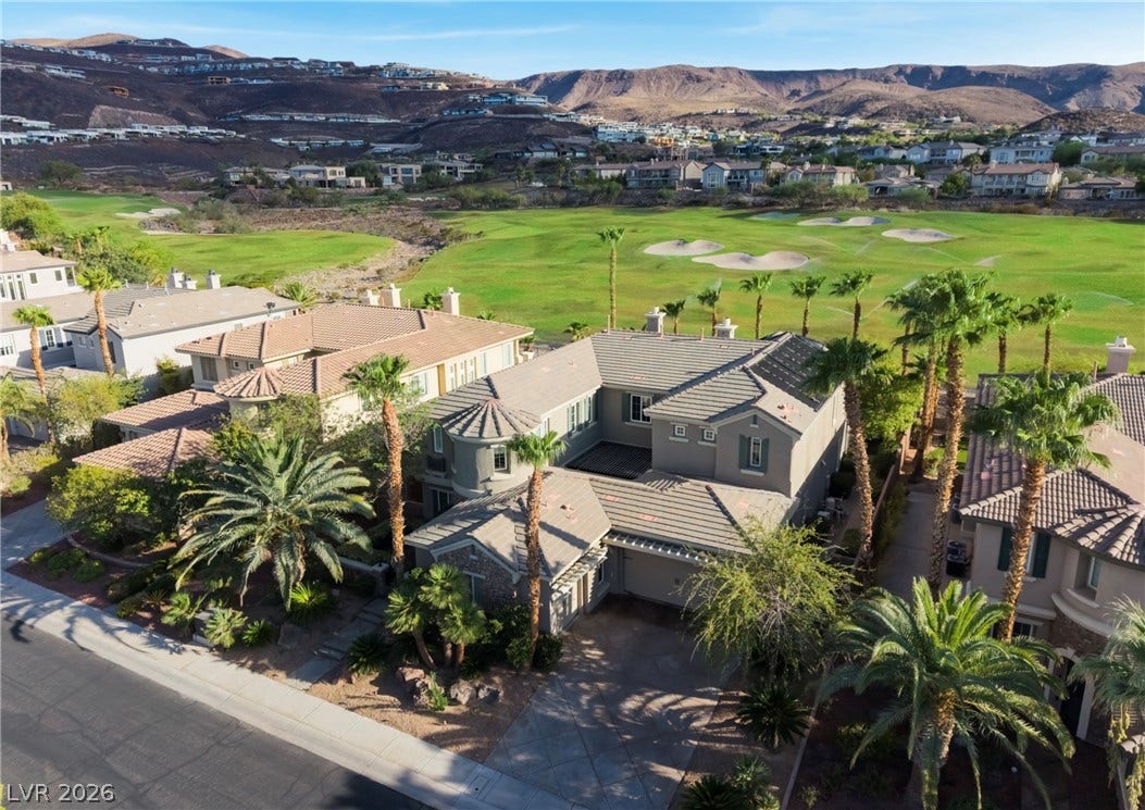 1343 Quiet River Avenue, Henderson, NV 89012 A spacious multi-level residence backs directly onto a lush golf course with dramatic mountain backdrops.