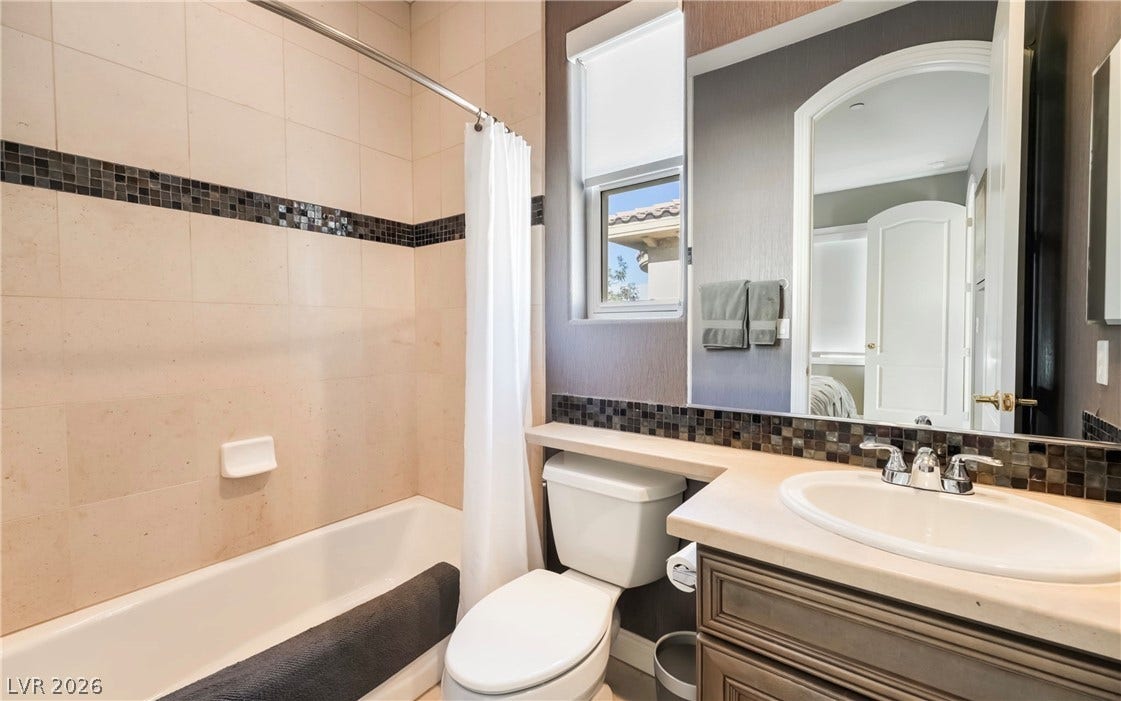 1343 Quiet River Avenue, Henderson, NV 89012 Fine tile detailing accents the shower surround and vanity area of this full bathroom.
