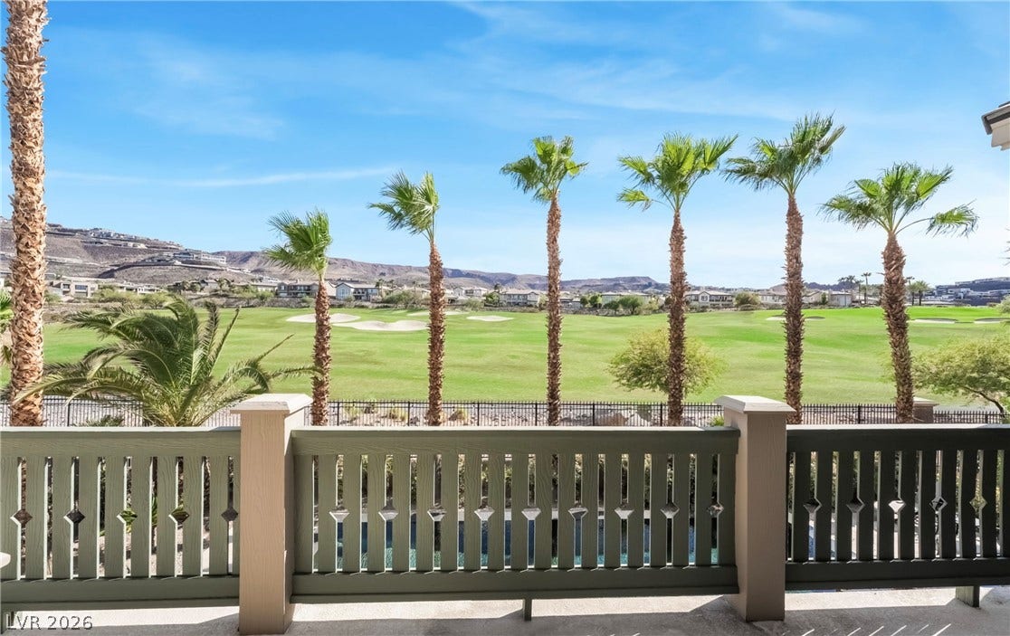 1343 Quiet River Avenue, Henderson, NV 89012 Rolling golf course greens stretch toward distant desert hills under clear blue skies.