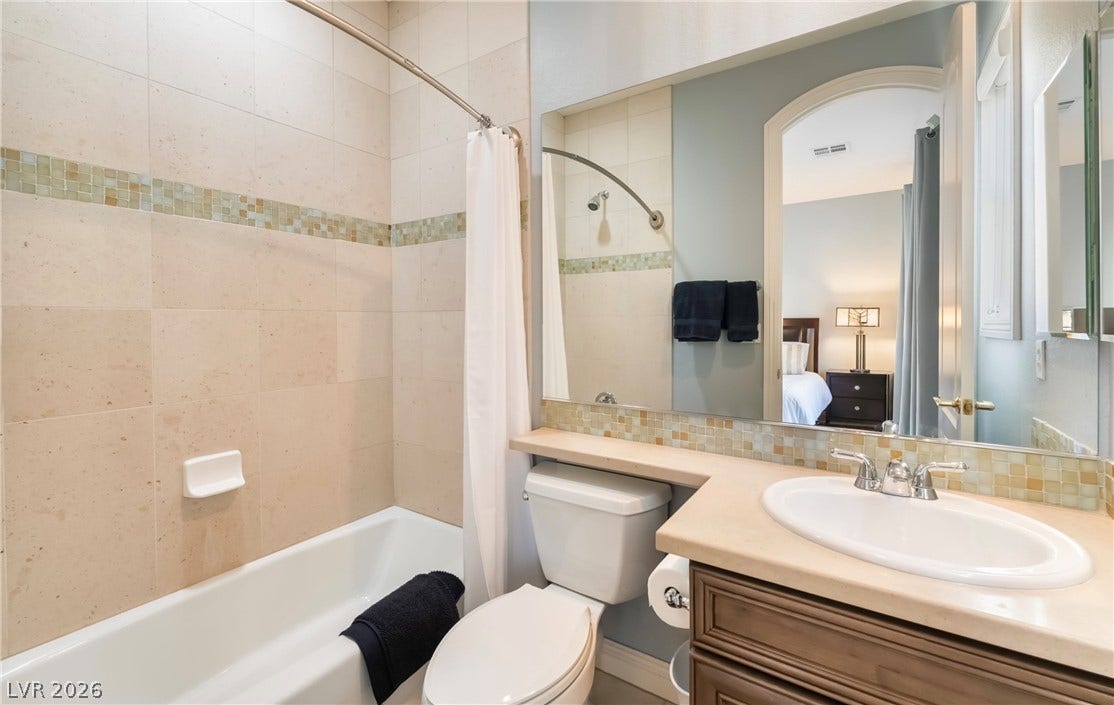 1343 Quiet River Avenue, Henderson, NV 89012 Tiled walls and a spacious vanity complete this functional bathroom layout.