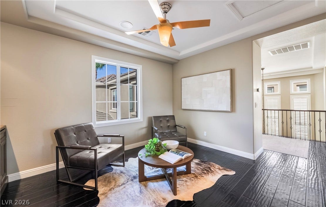 1343 Quiet River Avenue, Henderson, NV 89012 Dark wood flooring and a recessed tray ceiling define this upper-level sitting area.