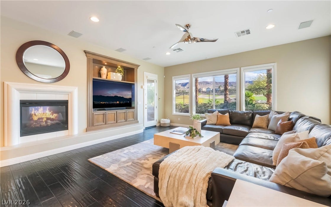 1343 Quiet River Avenue, Henderson, NV 89012 Gleaming dark hardwood flooring and built-in shelving anchor this comfortable living area.