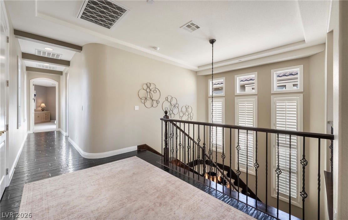 1343 Quiet River Avenue, Henderson, NV 89012 Rich hardwood floors and elegant wrought iron railings accent this upper level landing.
