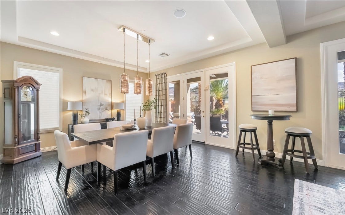 1343 Quiet River Avenue, Henderson, NV 89012 Gleaming dark hardwood flooring grounds this dining space lined with double French doors.