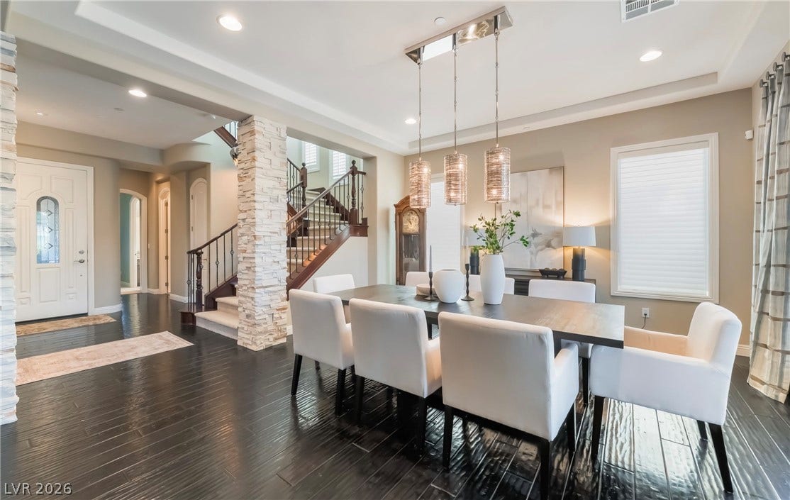 1343 Quiet River Avenue, Henderson, NV 89012 Rich dark wood floors anchor this open dining area seamlessly connected to the grand foyer.