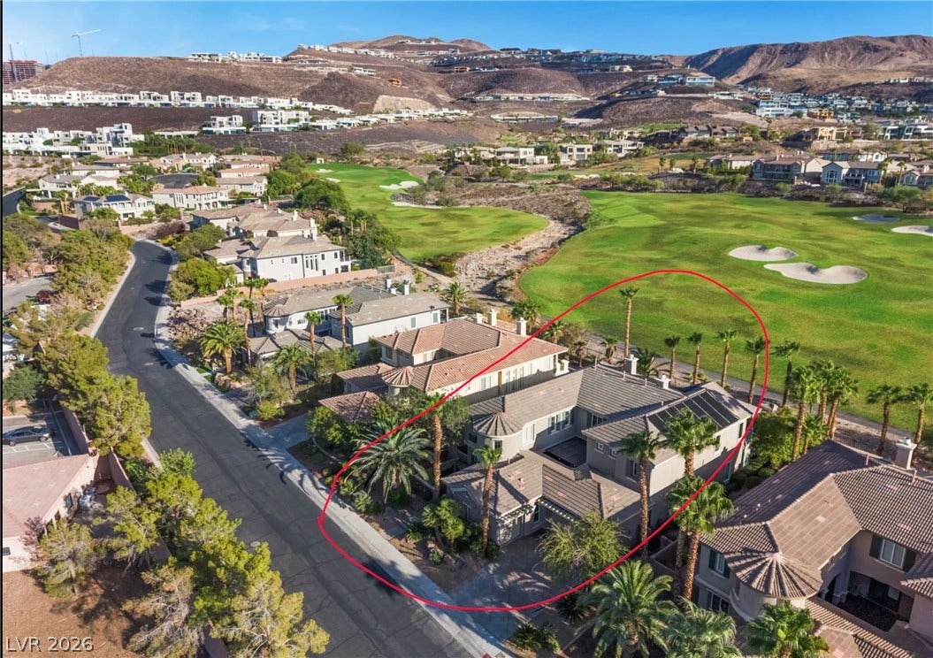 1343 Quiet River Avenue, Henderson, NV 89012 An elevated perspective showcases the custom residence bordering a lush, rolling golf course landscape.
