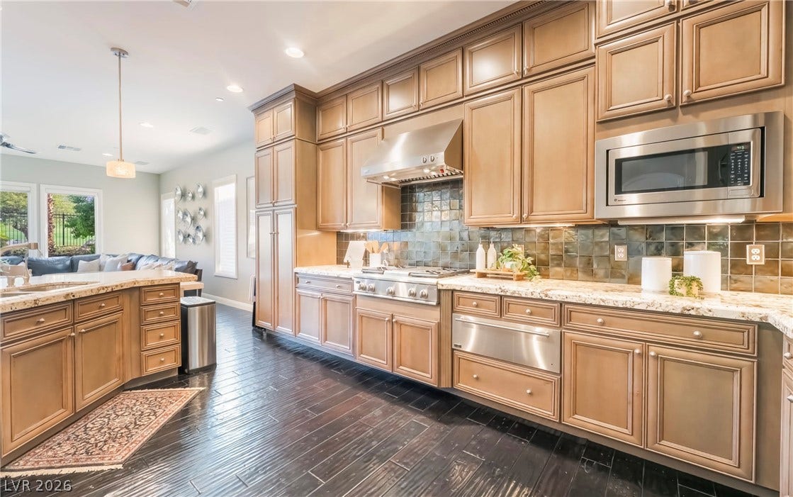 1343 Quiet River Avenue, Henderson, NV 89012 Gleaming hardwood floors and extensive cabinetry define this spacious, open culinary space.
