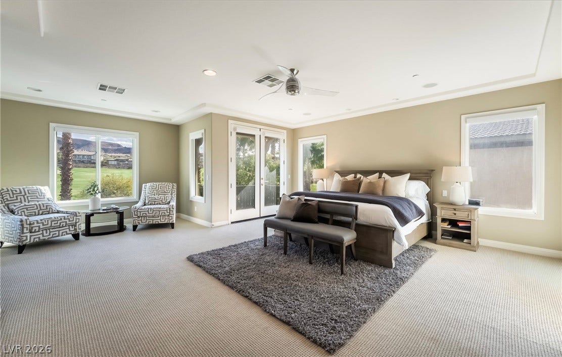 1343 Quiet River Avenue, Henderson, NV 89012 Double doors open to the outdoors in a generous bedroom featuring recessed lighting and crown molding.