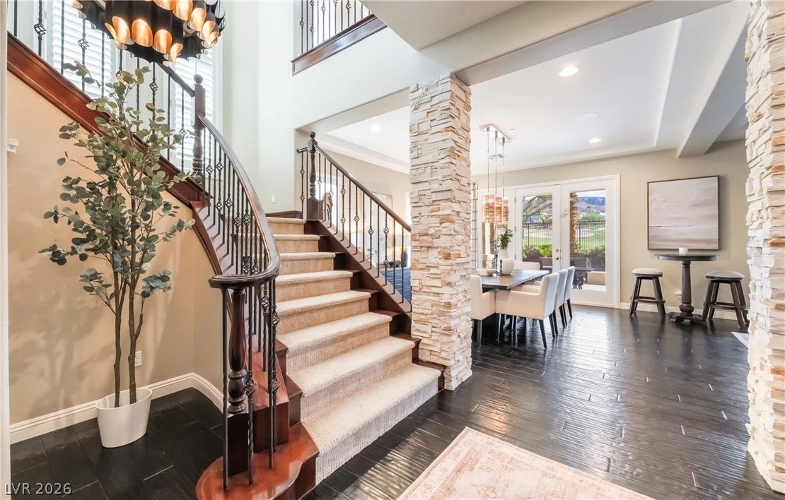 1343 Quiet River Avenue, Henderson, NV 89012 An elegant curved staircase anchors the welcoming entryway beside a bright, open dining area.