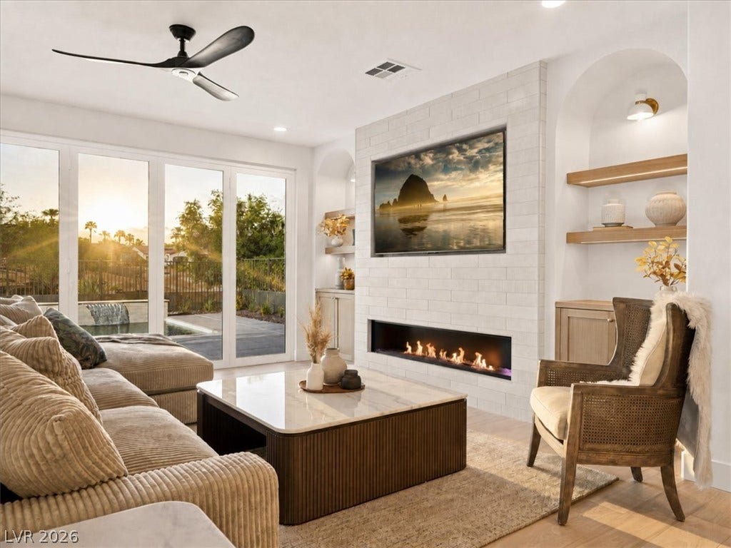 A modern tiled fireplace wall serves as the focal point in this light-filled room.