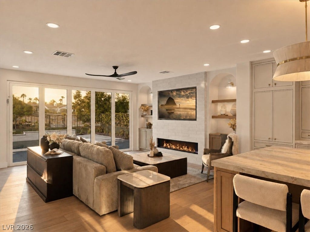 Warm wood flooring and a modern brick fireplace anchor this inviting living space.
