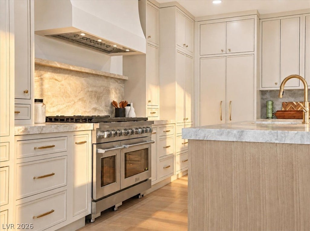 Elegant custom cabinetry and stone countertops frame this professional-grade chef's kitchen.