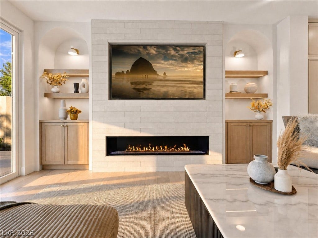 Custom arched built-ins flank a modern tiled fireplace with a sleek linear burner.