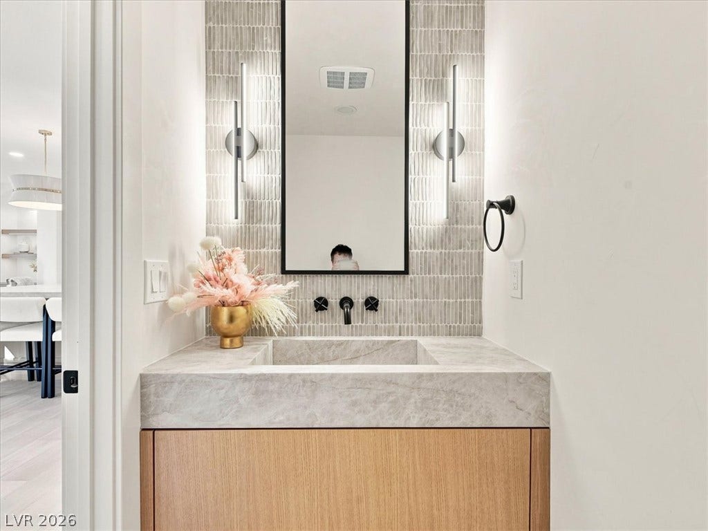 A modern floating vanity paired with premium stone counters elevates this sleek powder room.
