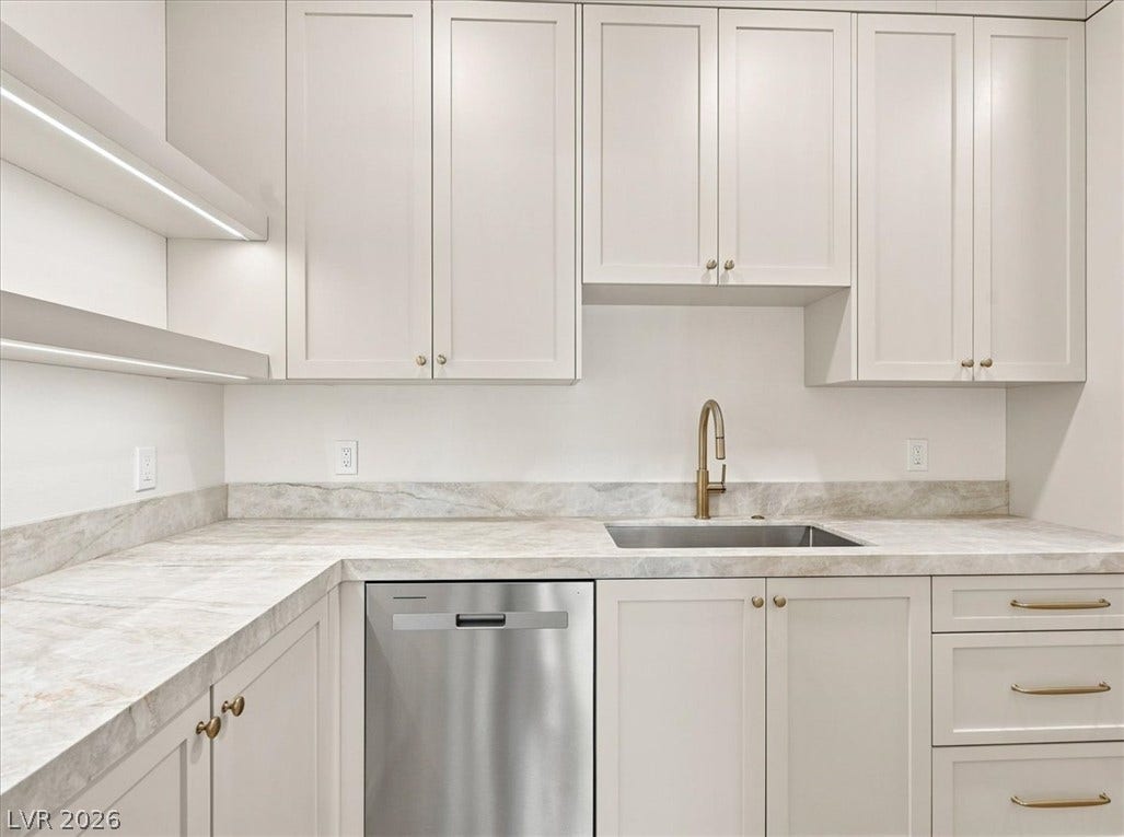 Elegant stone countertops and custom cabinetry define this highly functional kitchen workspace.