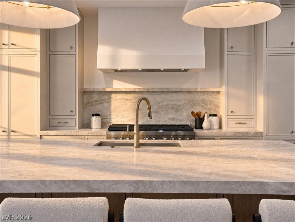 Sophisticated stone countertops and custom cabinetry anchor this gourmet kitchen space.