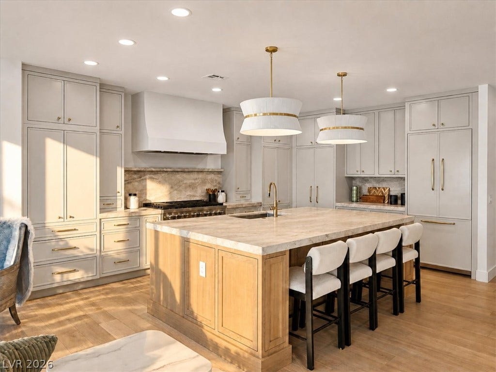 Fine cabinetry and stone surfaces define this expertly crafted kitchen workspace.