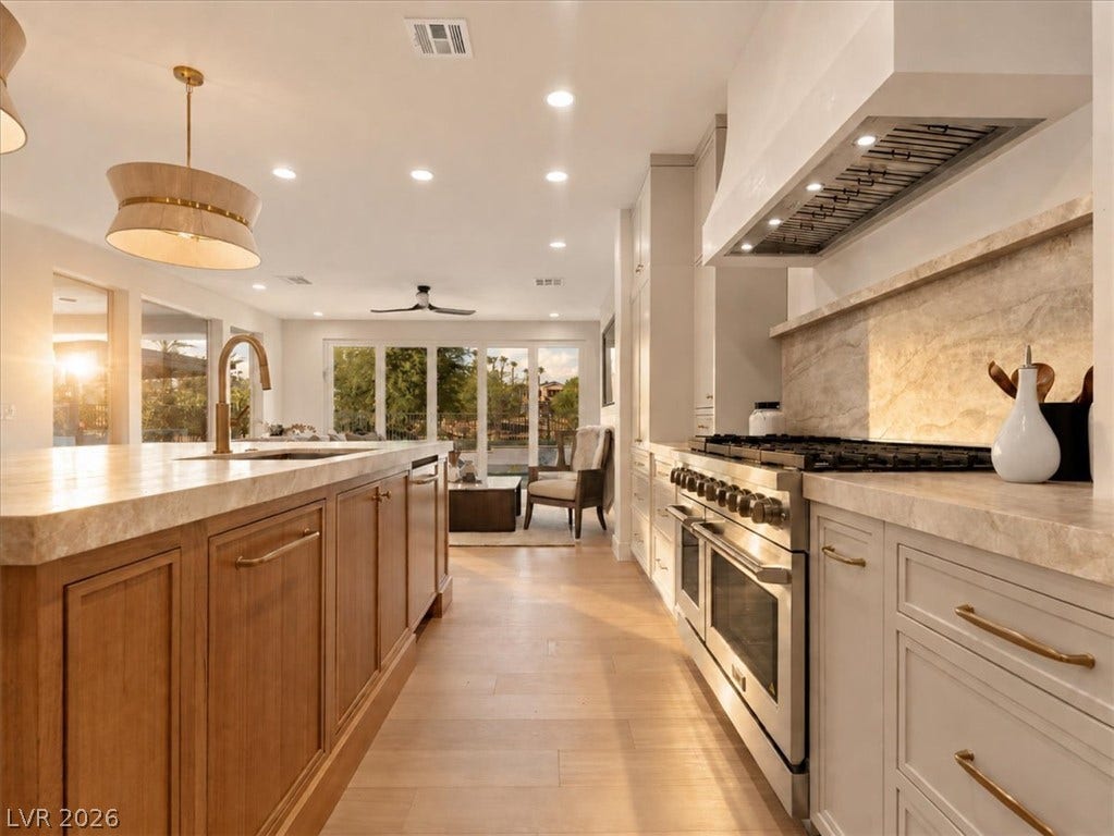 An open floorplan seamlessly connects this culinary workspace to the light-filled living area.