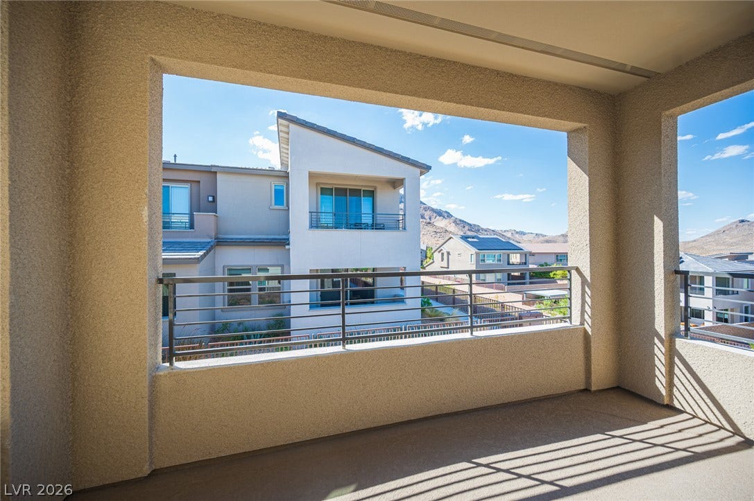 2545 Monolith Street, Las Vegas, NV 89138 An elevated, covered balcony framing scenic mountain and neighborhood vistas through its stucco archways.