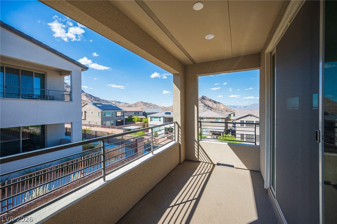 2545 Monolith Street, Las Vegas, NV 89138 An elevated private balcony frames picturesque mountain views beneath clear blue skies.