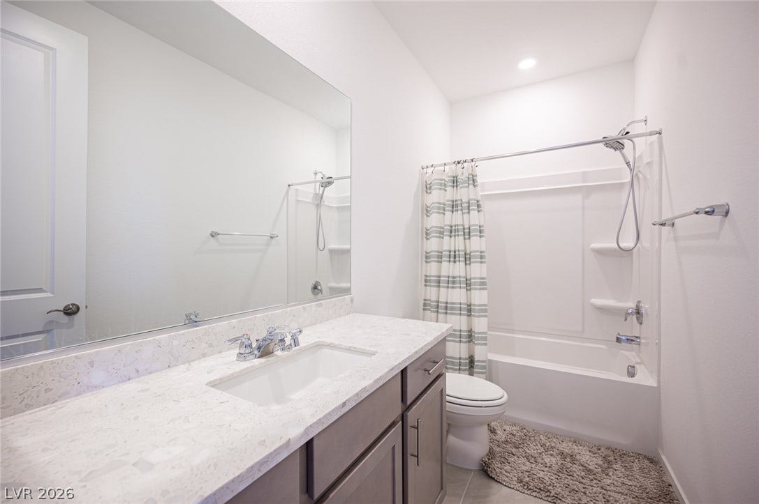 2545 Monolith Street, Las Vegas, NV 89138 Gleaming stone countertops and modern fixtures elevate this clean, stylish bathroom.