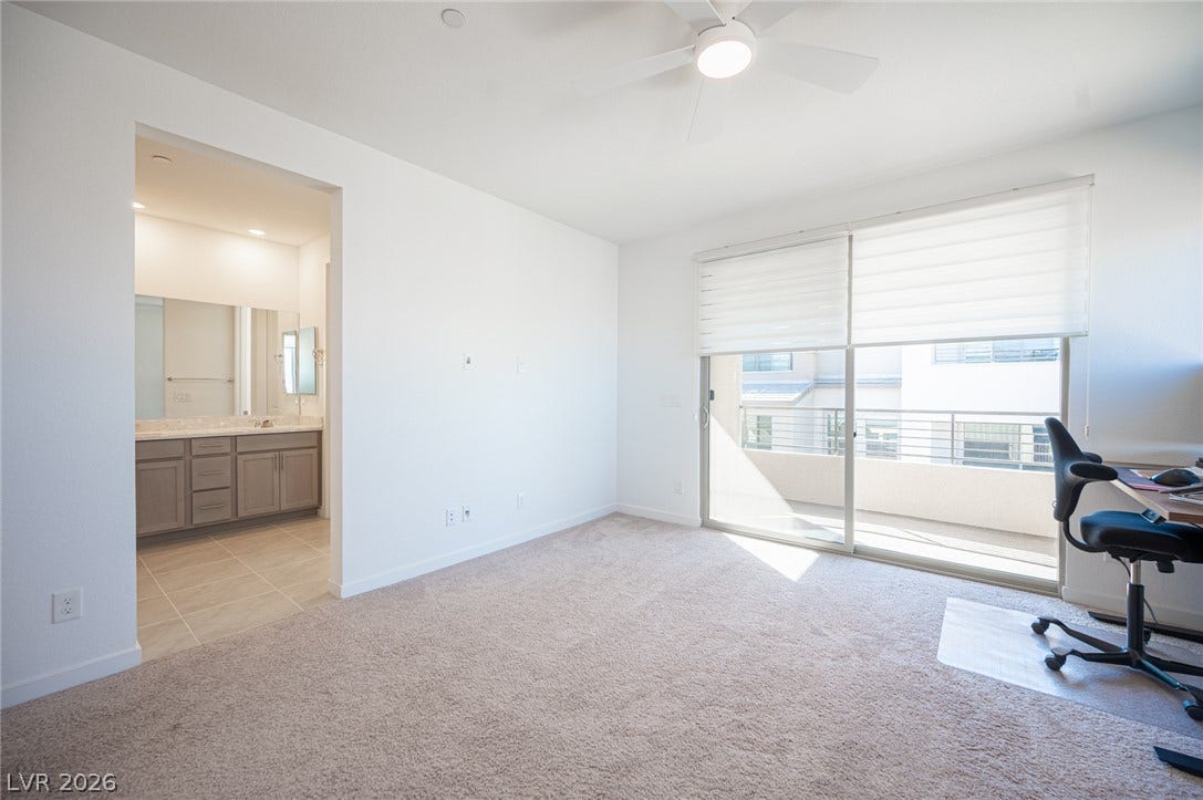 2545 Monolith Street, Las Vegas, NV 89138 Sliding glass doors open to a private balcony from this carpeted bedroom suite.