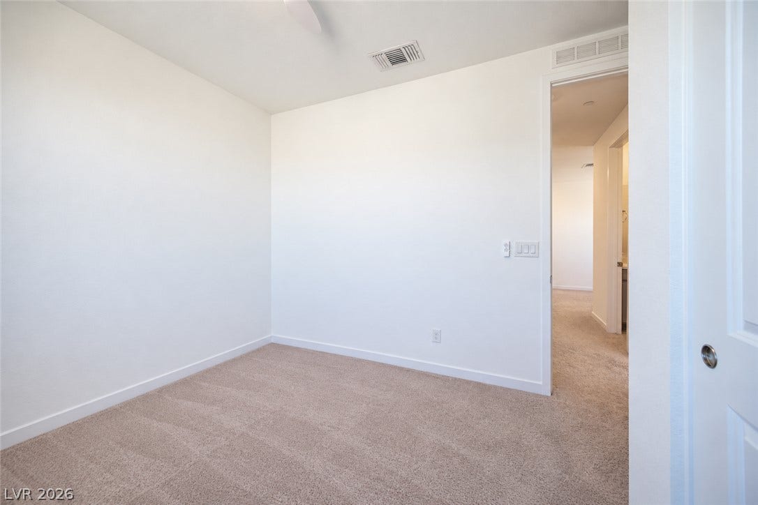 2545 Monolith Street, Las Vegas, NV 89138 Plush carpeting and clean lines define this versatile secondary bedroom space.