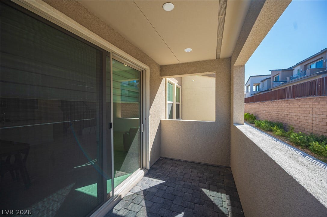 2545 Monolith Street, Las Vegas, NV 89138 Sliding glass doors open to a private covered patio paved with classic stone pavers.