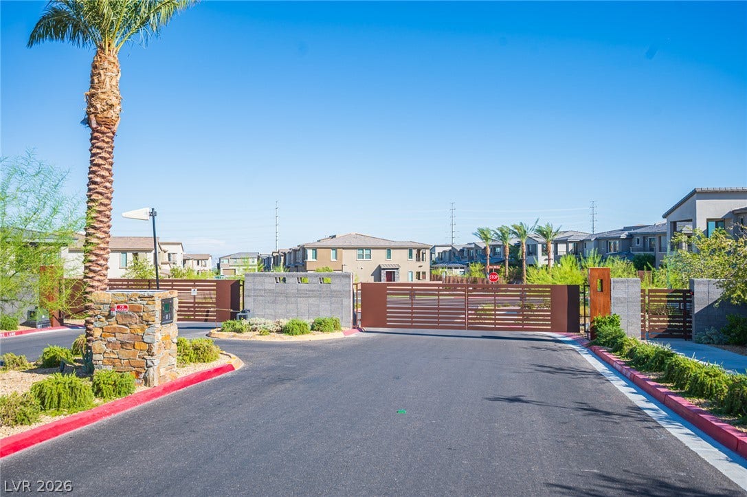 2545 Monolith Street, Las Vegas, NV 89138 Secure gated entry welcomes residents home along a neatly paved asphalt driveway.