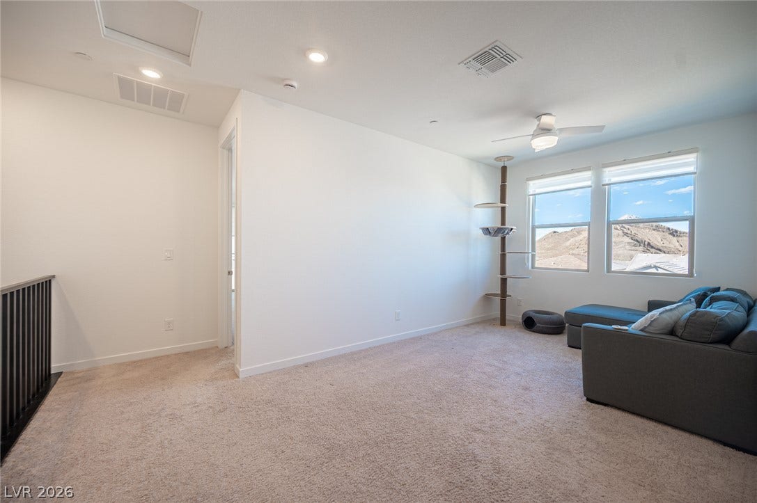 2545 Monolith Street, Las Vegas, NV 89138 Plush carpeting and large windows highlighting elevated views define this versatile upper loft space.