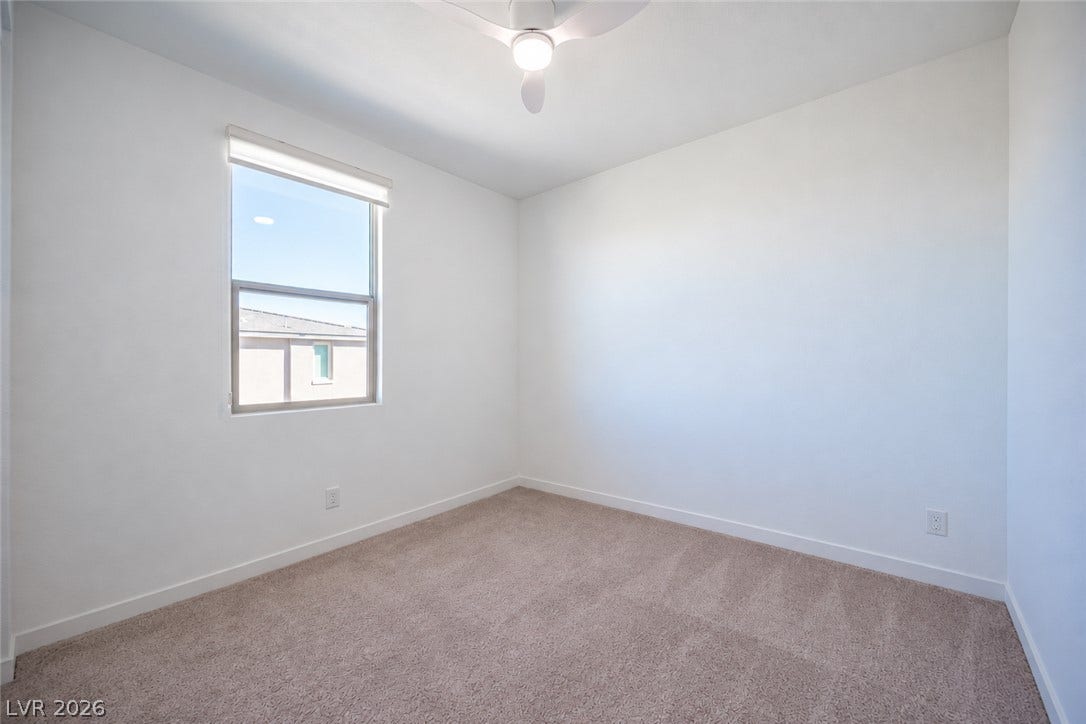 2545 Monolith Street, Las Vegas, NV 89138 Plush carpeting and a large single window create a cozy, clean atmosphere in this bedroom.