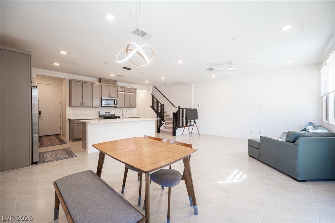 2545 Monolith Street, Las Vegas, NV 89138 Gleaming tile flooring spans a modern open-concept living area adjacent to a sleek kitchen.