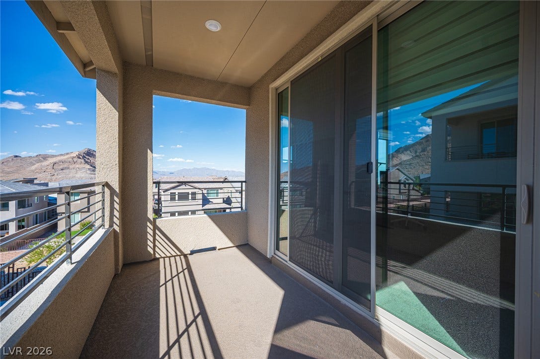 2545 Monolith Street, Las Vegas, NV 89138 Sliding glass doors open to a private covered balcony overlooking scenic neighborhood and mountain vistas.