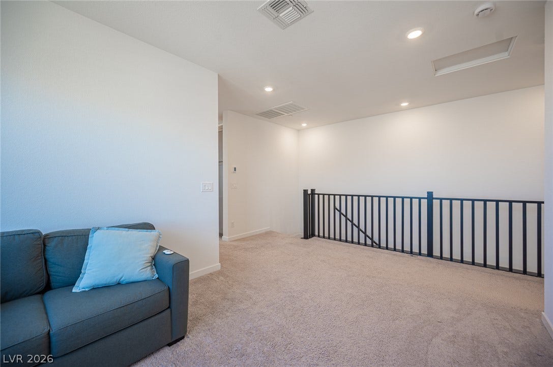 2545 Monolith Street, Las Vegas, NV 89138 A versatile upper-level loft area features wall-to-wall carpeting and recessed lighting.