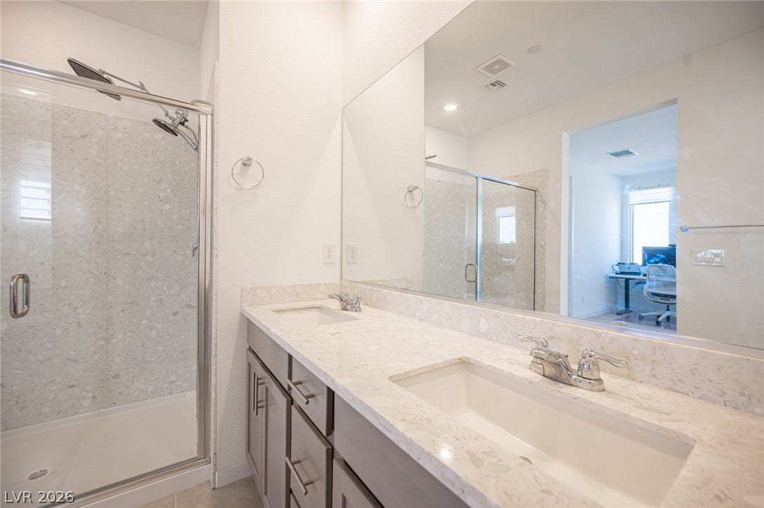 2545 Monolith Street, Las Vegas, NV 89138 Clean lines and a spacious dual vanity define this modern bathroom.