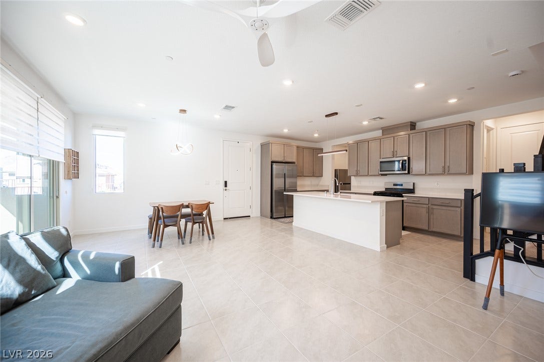 2545 Monolith Street, Las Vegas, NV 89138 An open concept floor plan seamlessly connects the kitchen and dining areas over tiled floors.
