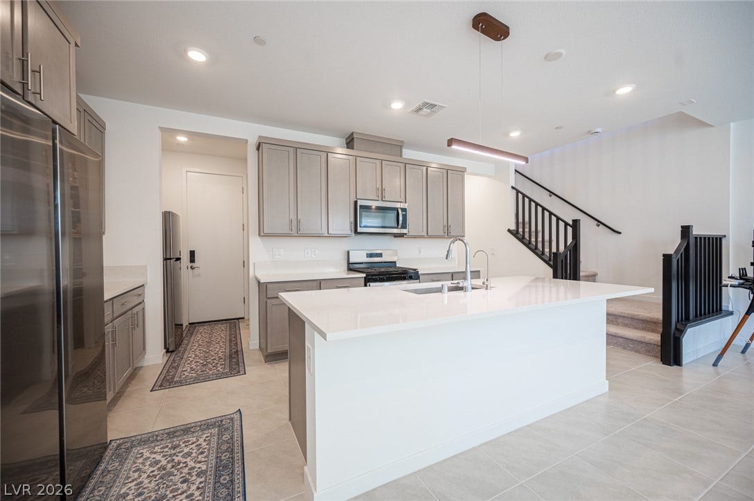 2545 Monolith Street, Las Vegas, NV 89138 Modern cabinetry and stone countertops frame a spacious center island with breakfast bar potential.