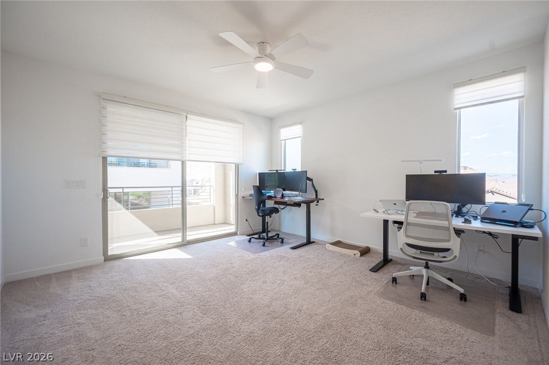 2545 Monolith Street, Las Vegas, NV 89138 Glass sliding doors open to a private balcony from this carpeted workspace.