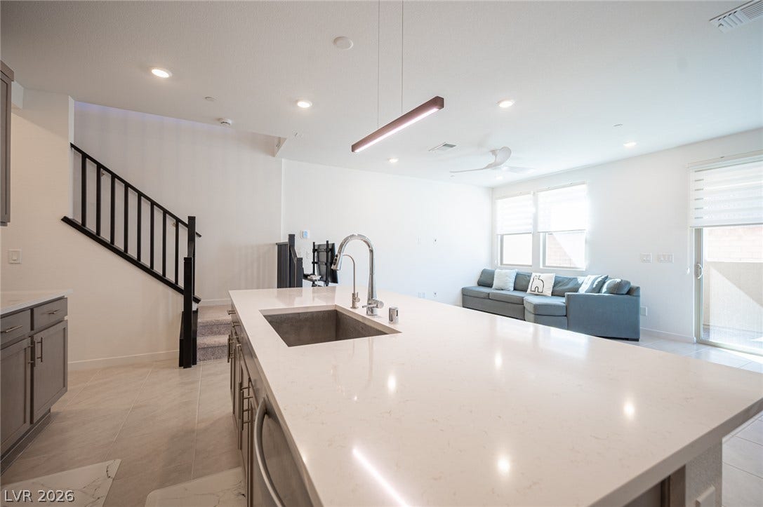 2545 Monolith Street, Las Vegas, NV 89138 Clean lines and a spacious stone island anchor this open-concept main floor layout.