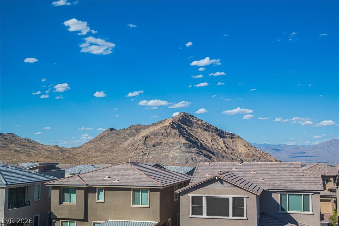 2545 Monolith Street, Las Vegas, NV 89138 Dramatic mountain vistas rise high above the surrounding neighborhood rooftops.
