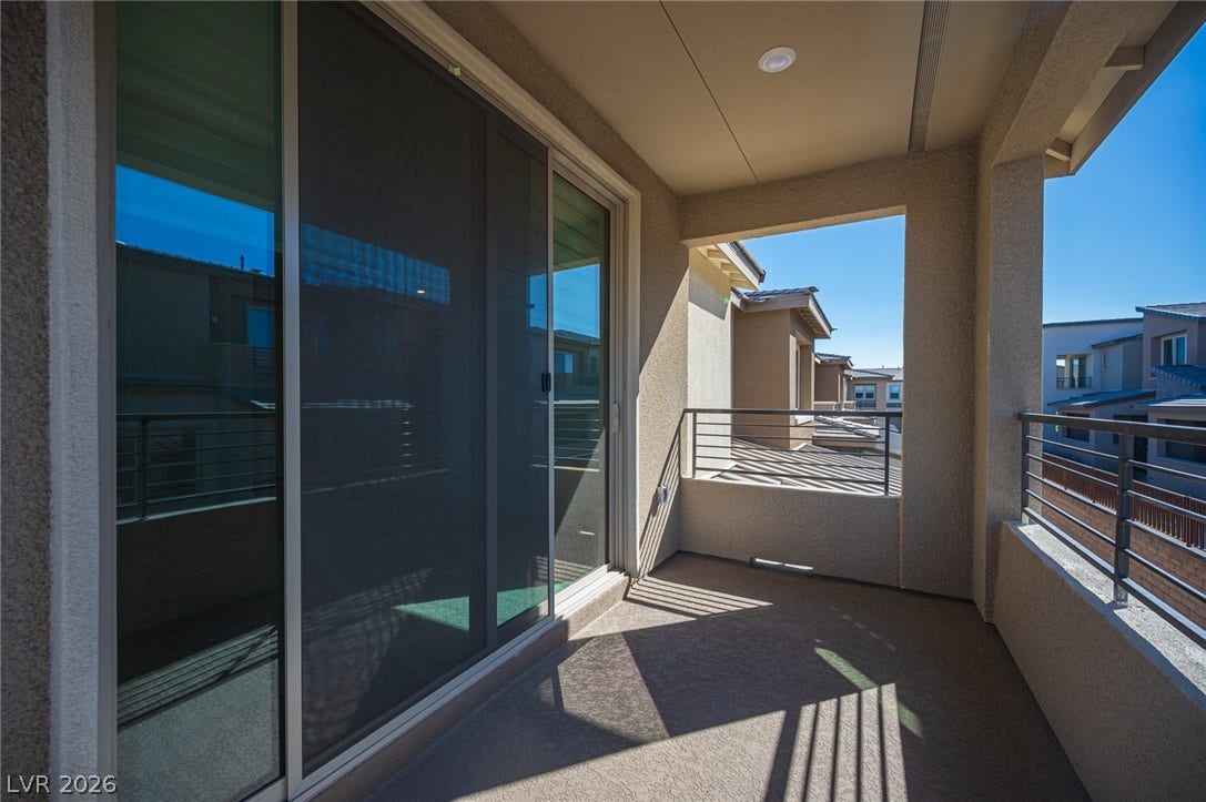 2545 Monolith Street, Las Vegas, NV 89138 Sliding glass doors open to a private covered balcony overlooking the surrounding neighborhood.