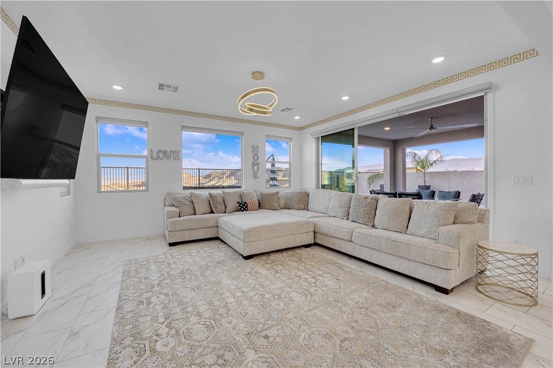 12415 Aster Hills Avenue, Las Vegas, NV 89138 An open-concept living area flows seamlessly to the outdoor patio through sliding glass doors.
