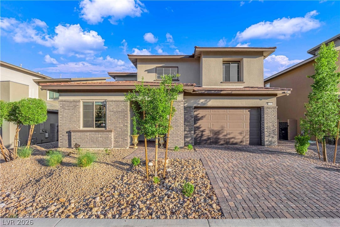 12415 Aster Hills Avenue, Las Vegas, NV 89138 A striking modern facade features a paver driveway, stone accents, and desert landscaping.
